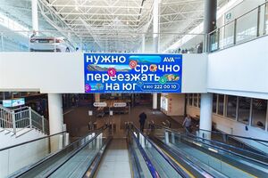 Реклама на экране над траволаторами со стороны гипермаркета в ТЦ «Мега Омск» на бульваре Архитекторов, 35